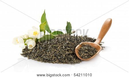 Green tea, wooden spoon and blossoming jasmine