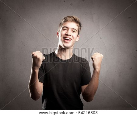 portrait of a young man celebrating being a winner
