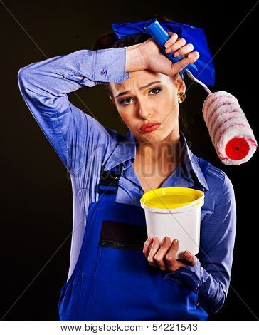 Tired woman builder with paint cans.