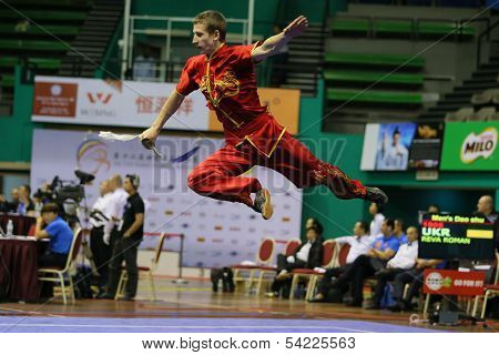 KUALA LUMPUR - NOV 03: Ukraine's Reva Roman performs with a sword in the Men's 'Daoshu' Event at the 12th World Wushu Championship on November 03, 2013 in Kuala Lumpur, Malaysia.