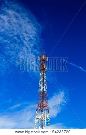 Telecom Tower In The Afternoon Bright Sunlight And Cloudy Blue Sky