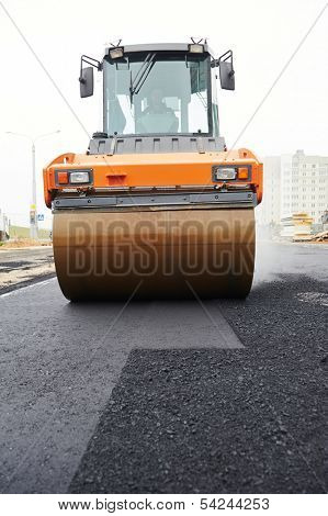 Heavy cibration roller compactor at asphalt pavement works for road repairing