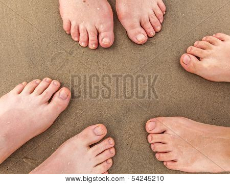 Feet Of Family At The Beach