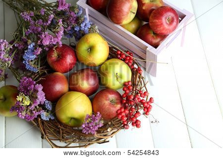 Juicy apples in box on white wooden table