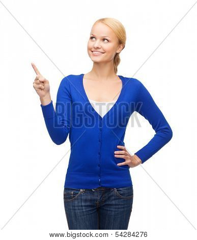 advertisement concept - attractive young woman in casual clothes pointing her finger up