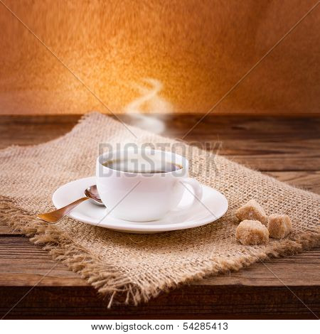 Coffee cup and saucer on  wooden table.