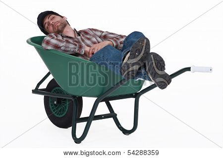 Worker taking a nap in wheelbarrow