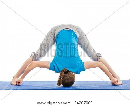 Yoga - young beautiful slender woman yoga instructor doing Wide Legged standing Forward Bend D (Prasarita Padottanasana D) asana exercise isolated on white background