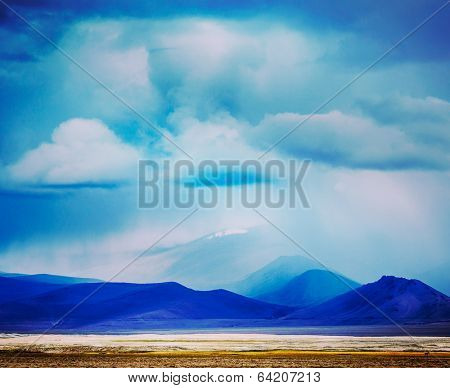 Vintage retro effect filtered hipster style travel image of Gathering storm in Himalayas mountains. Ladakh, India