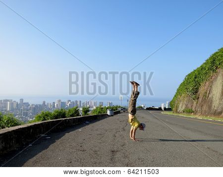 Man Handstands At Mountain Lookout Point Above The City Of Honolulu