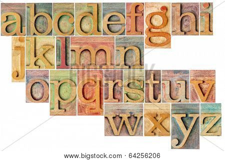 complete English lowercase alphabet - a collage of 26 isolated antique wood letterpress printing blocks, stained by color inks