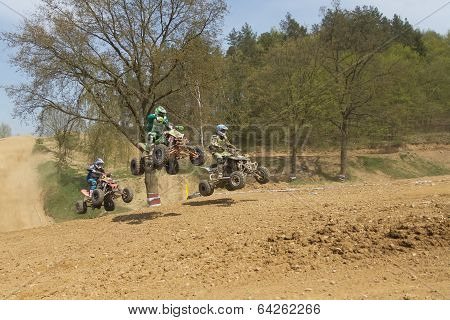 Trinity Of Quad Riders Jumping