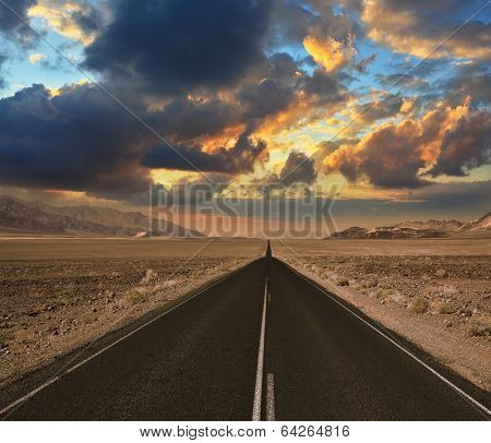 The excellent quality of American roads. Straight as an arrow groomed and smooth the road to dry and wild desert Death Valley. Sunset