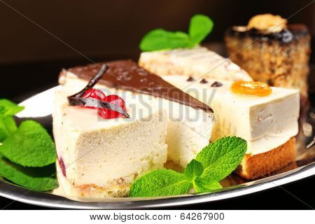 Assortment of pieces of cake, on dark background