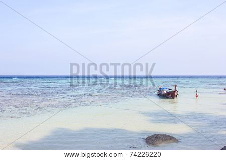 LIPE ISLAND, SATUN, THAILAND - SEP29, 2014: Fisherman Sailed Longtail Boat On The Beach
