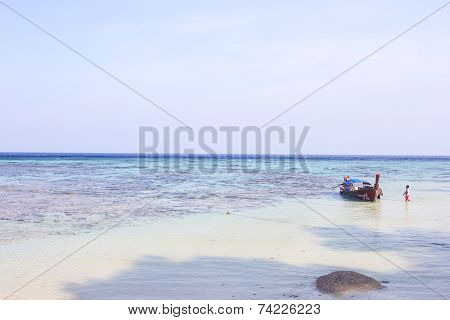 LIPE ISLAND, SATUN, THAILAND - SEP29, 2014: Fisherman Sailed Longtail Boat On The Beach