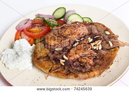 Musakhan, traditional Palestinian sumac chicken, on a plate with a salad and yoghurt,high angle