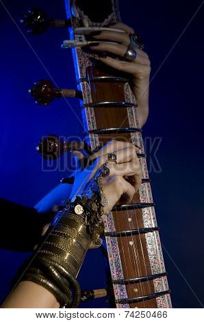 Beautiful Young Indian Woman In Traditional Clothing With Oriental Jewelry Playing The Sitar