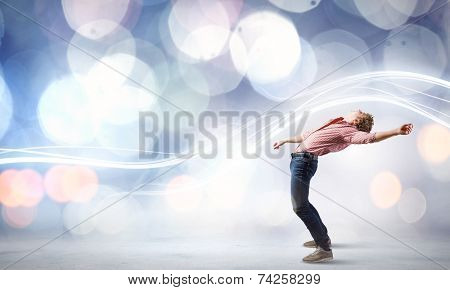 Young guy in casual evading from light rays