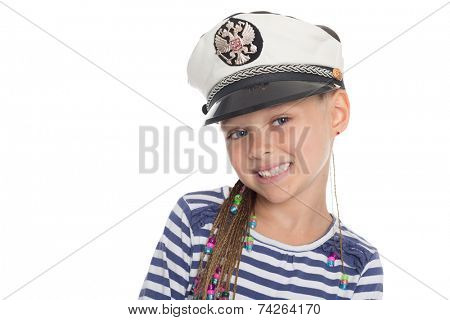 Happy little girl six years old in a suit cabin boy. Girl is six years old. On her cap emblem of Russia.