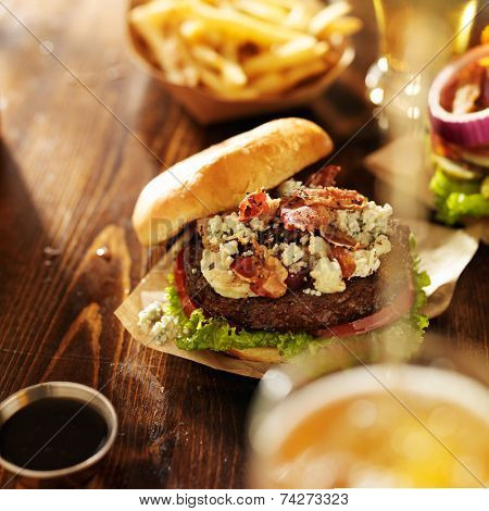 gourmet bleu cheese burgers with beer being poured