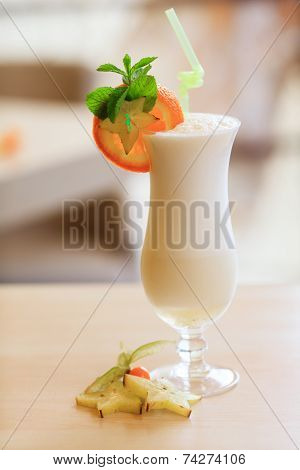 Milk cocktail with orange and carom
