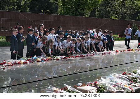 Schoolchildren Put Flowers To The Eternal Fire At The Memorial