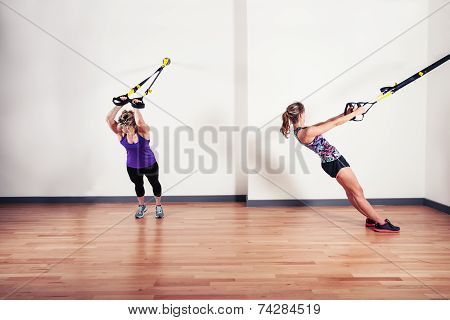 Two Women Working Out With Straps