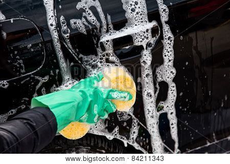 Outdoor car wash with yellow sponge