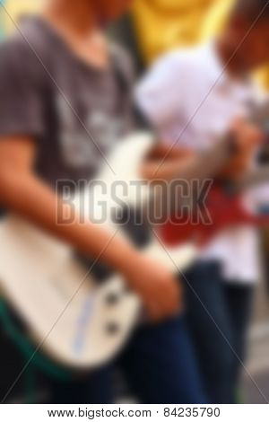 Blurred Image Of Guitarists Playing Guitar.