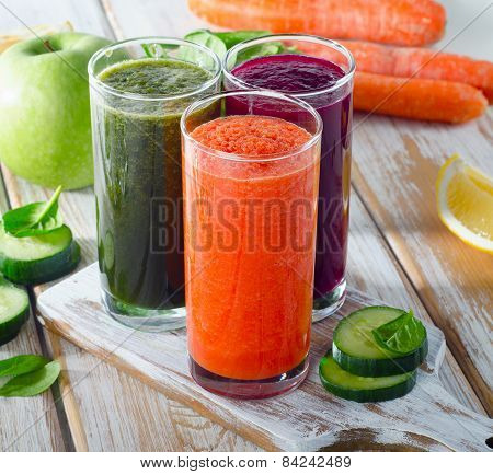 Vegetable Juices On A White Wooden Background