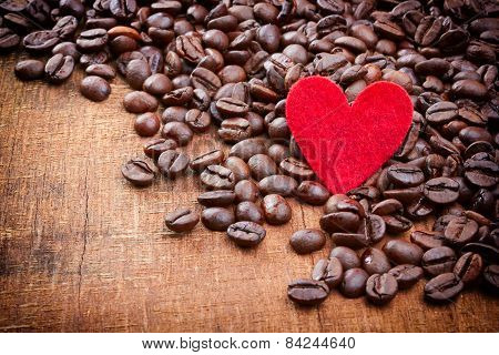 Red Heart And Coffee Beans On Wood Background