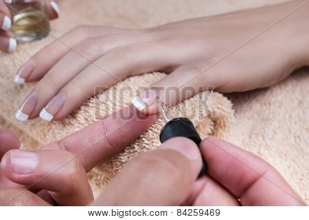 Manicure. Applying the oil