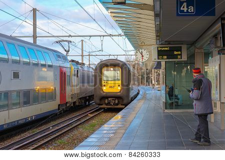 Regional Train in the station Bruges with clock