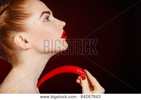 Sexy brunette girl with red cayennes isolated on black