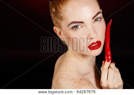 Sexy brunette girl with red cayennes isolated on black