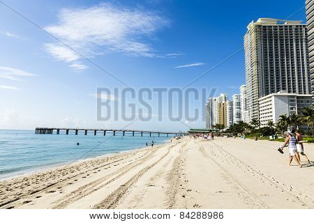 People Relax Near The Pier In Sunny Isles Beach