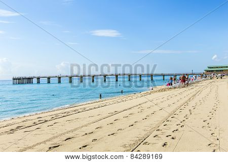 People Relax Near The Pier In Sunny Isles Beach