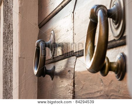 Brassy Doorknob On Wooden Door, Two Handles