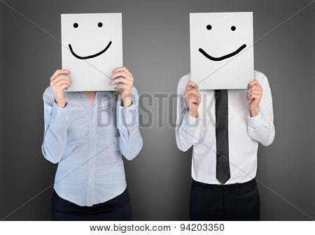 Smile shape on paper in hands of business woman and man