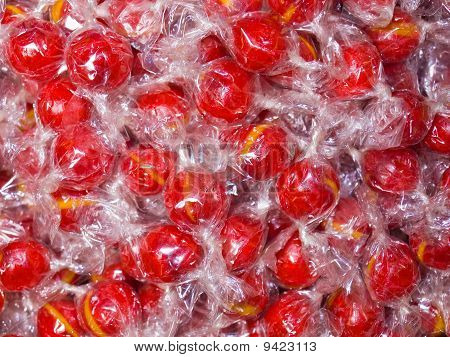Farverige Hard Candy i indpakning som en baggrund