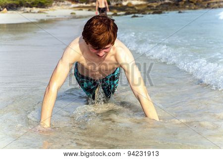 Boy At The Beautiful Beack Trains Push-ups