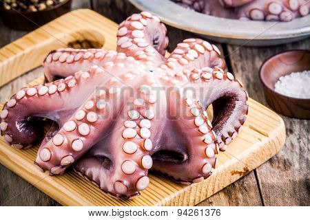 Whole Fresh Raw Octopus  On Cutting Board With Sea Salt