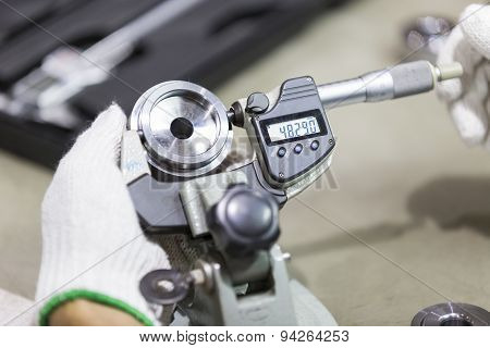 Operator Inspection Automotive Part By Micrometer