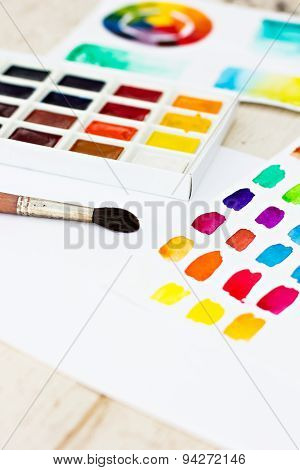 Workplace artist - paper paint brushes color wheel