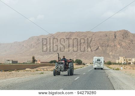 The Farmar Rides Truck By In Opposite Directions With Recreational Vehicle Of Tourist