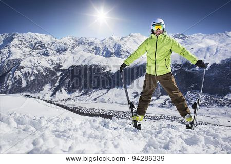 Young men on skies in winter mountain resort