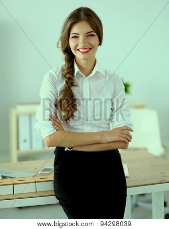 Attractive businesswoman with her arms crossed stnding