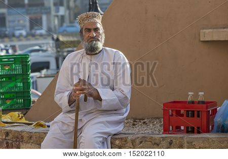 Nizwa Oman October 13th 2016: old mad resting on Nizwa market