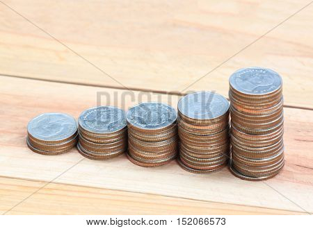 silver coin stack in business growth concept on wood floor.